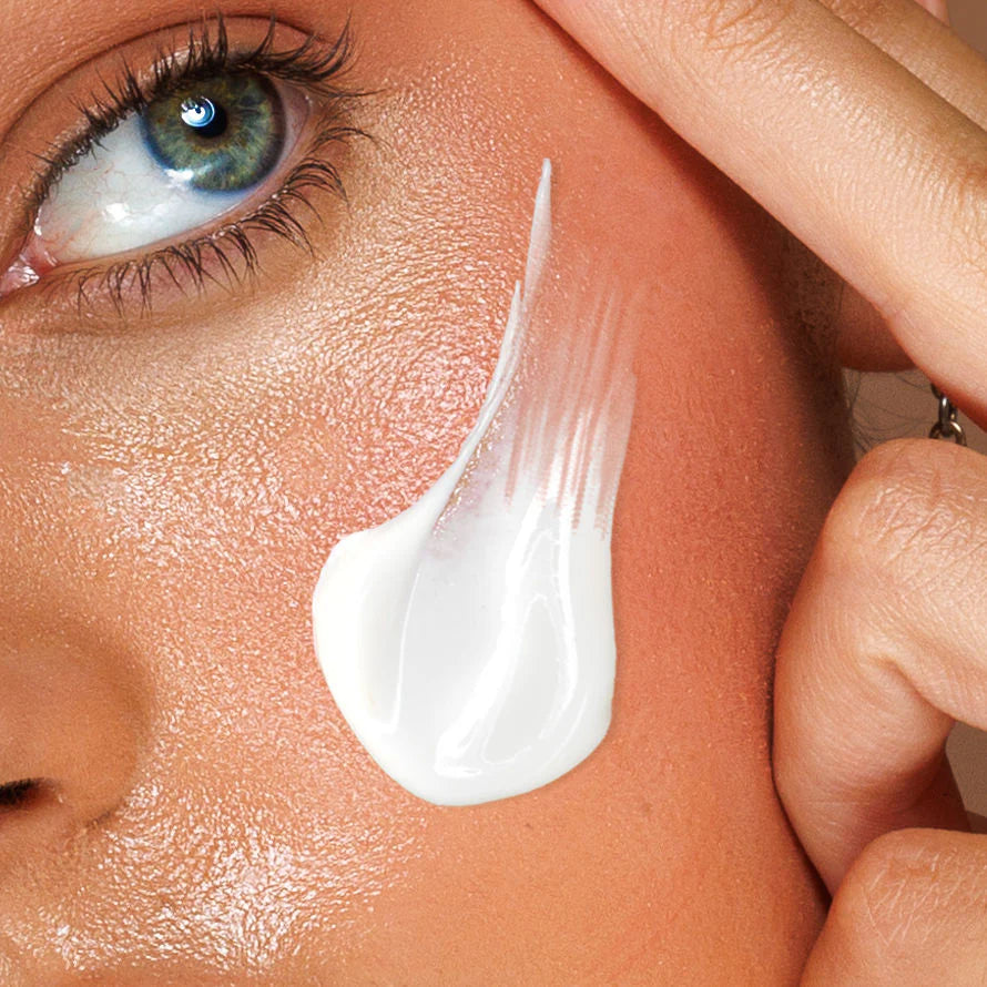 Close-up of a hand applying white cream to a person's face. Avocado Zinc SPF 50 Natural Physical Sunscreen 100ml