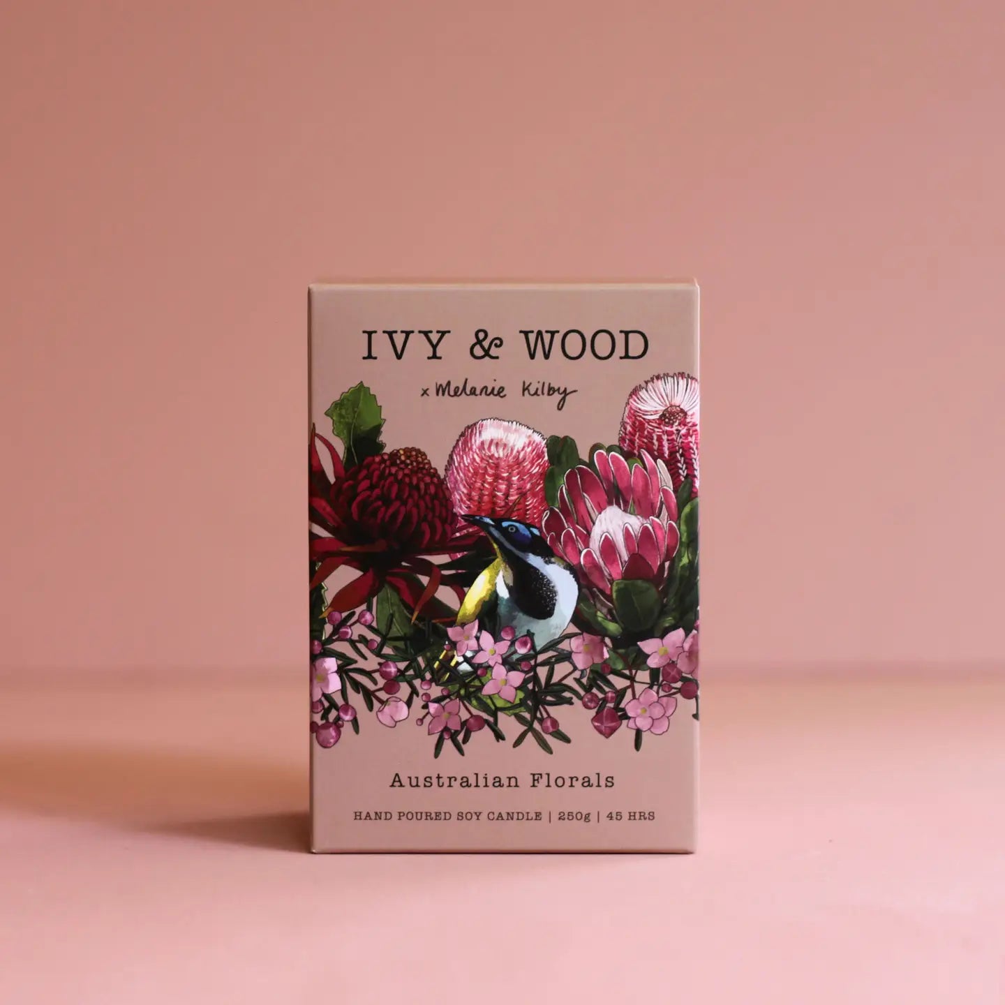 IVY & WOOD candle packaging with floral design on a pink background