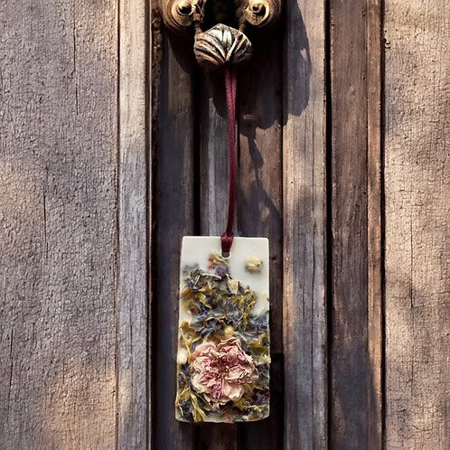 Dusty Rose Perfume Infused Wax Tablet hanging on a wooden door
