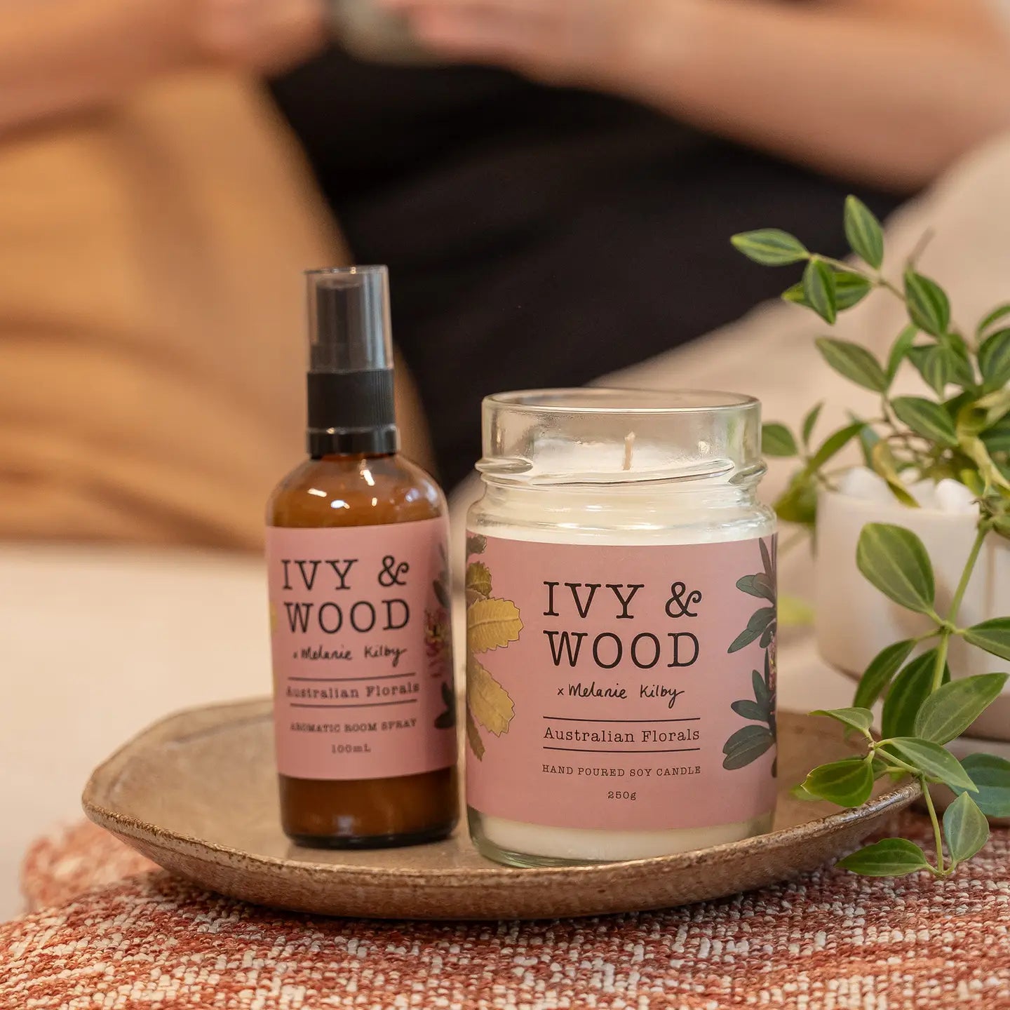 Ivy & Wood Australiana: Australian Florals Soy Candle and room spray on a wooden tray with a blurred background